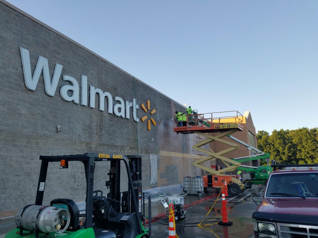 Professional on a lift vapor blasting a Walmart Store